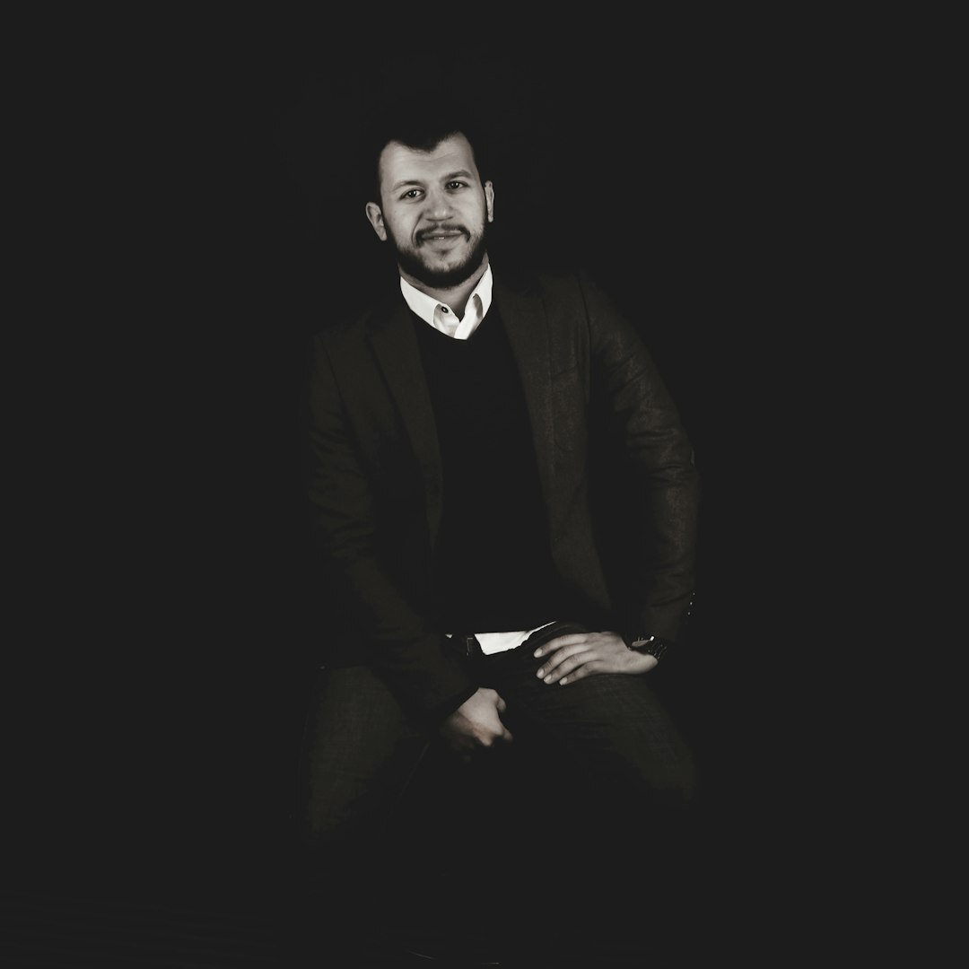 Professional headshot of a man in business casual attire
